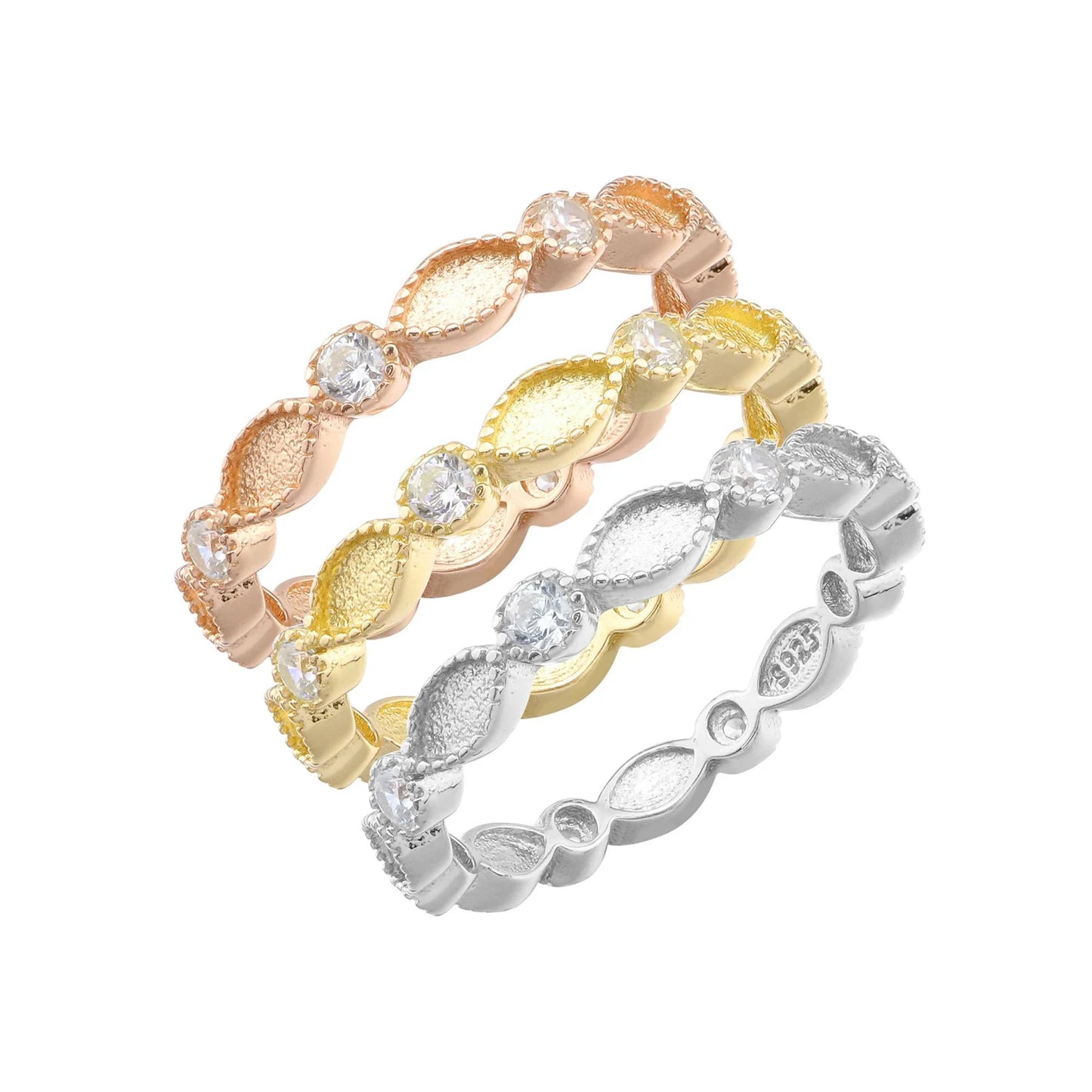 Three gold and silver rings with diamond-like stones on a white background