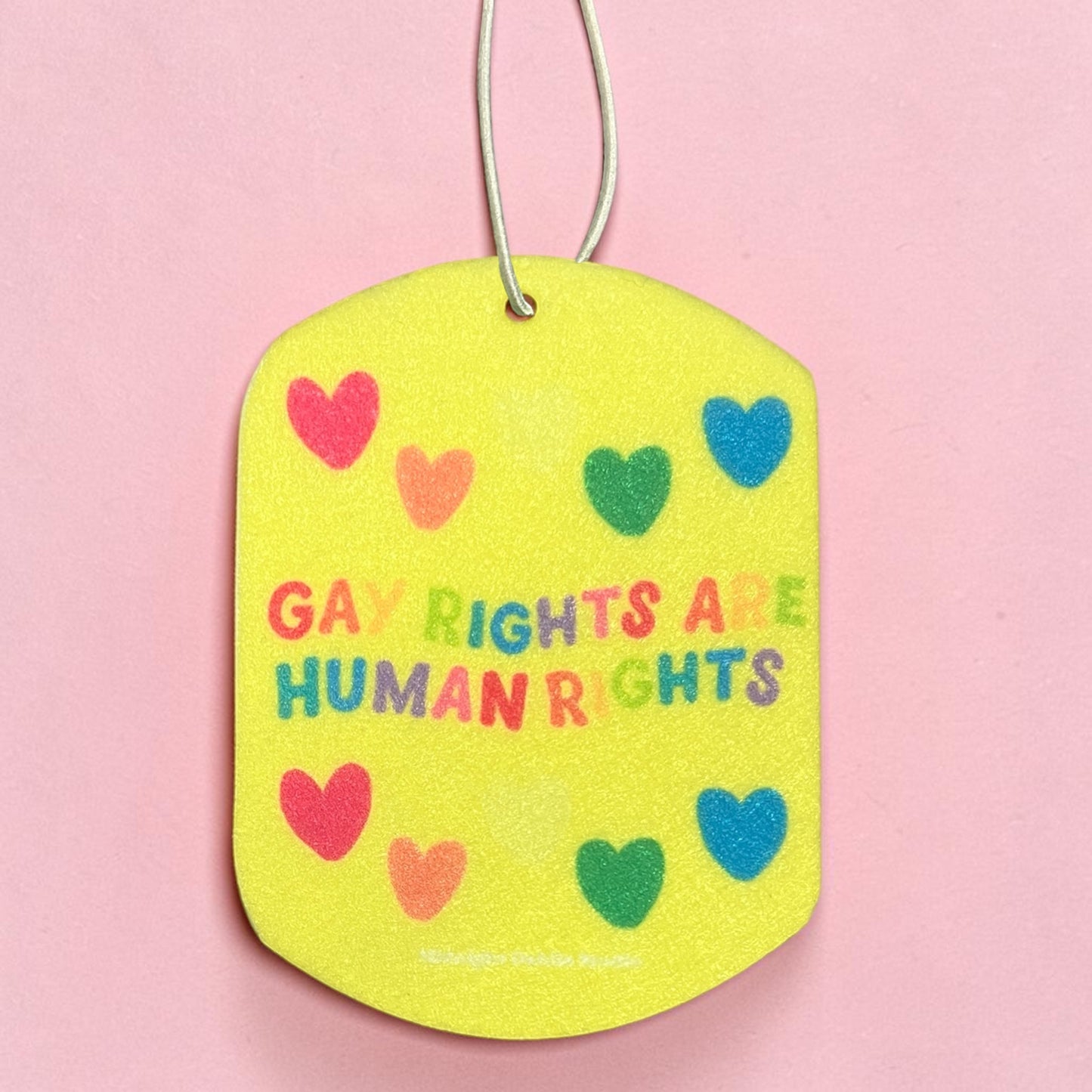 Yellow tag with 'Gay rights are human rights' text and colorful hearts on a pink background