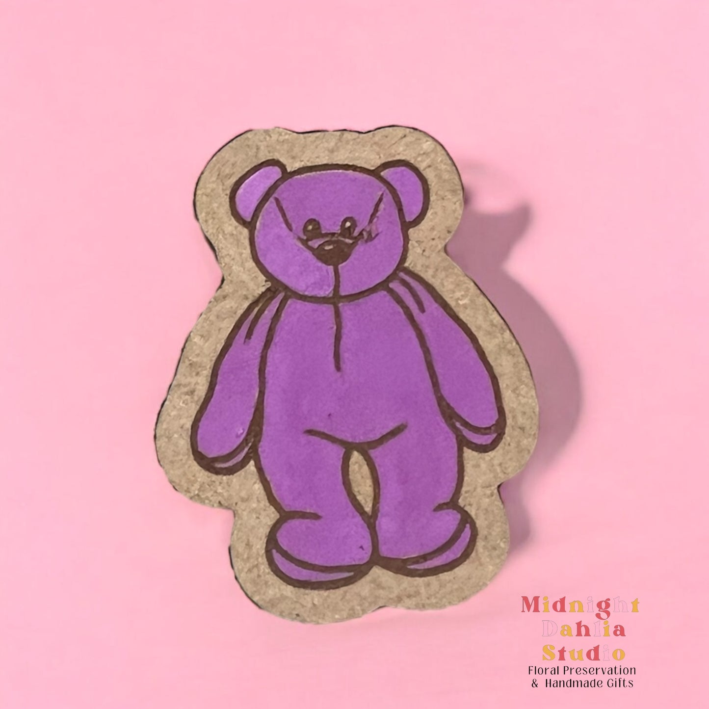 A wooden pin with a hand painted purple beanie baby beanbag bear. Retro and vintage vibes.