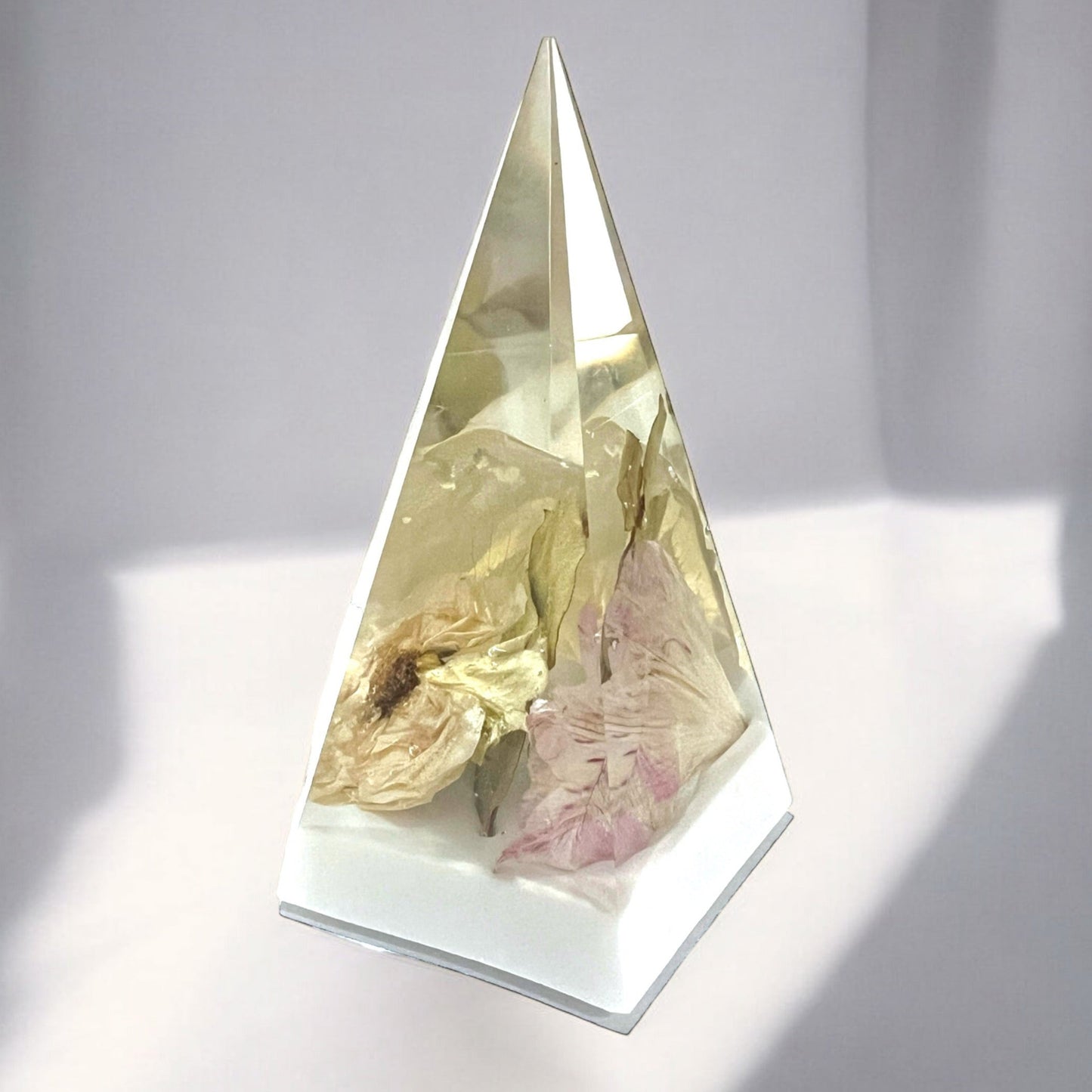 A custom ring holder stand with white and light pink flowers in crystal clear resin . A beautiful add-on for a bridal bouquet preservation.