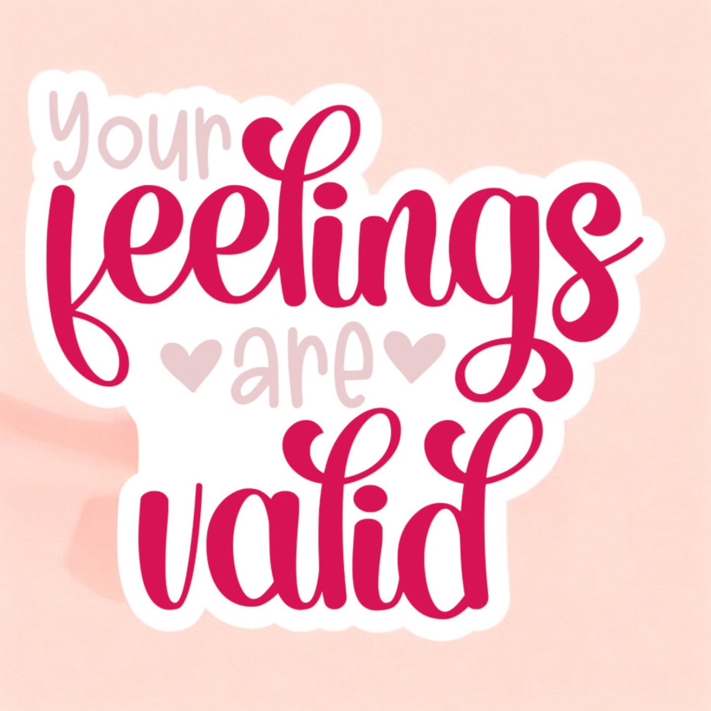 a white sticker that reads your feelings are valid in hot pink