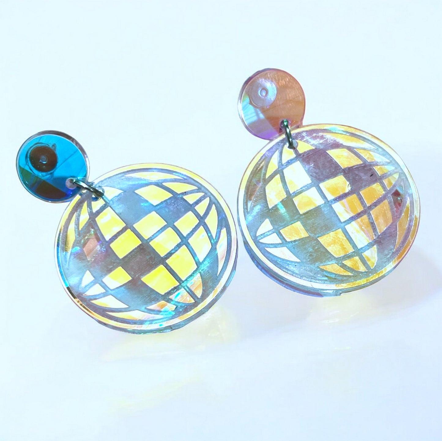 A pair of iridescent disco ball dangle earrings laser cut. Beautiful jewelry for a woman or teen, especially for a music concert.