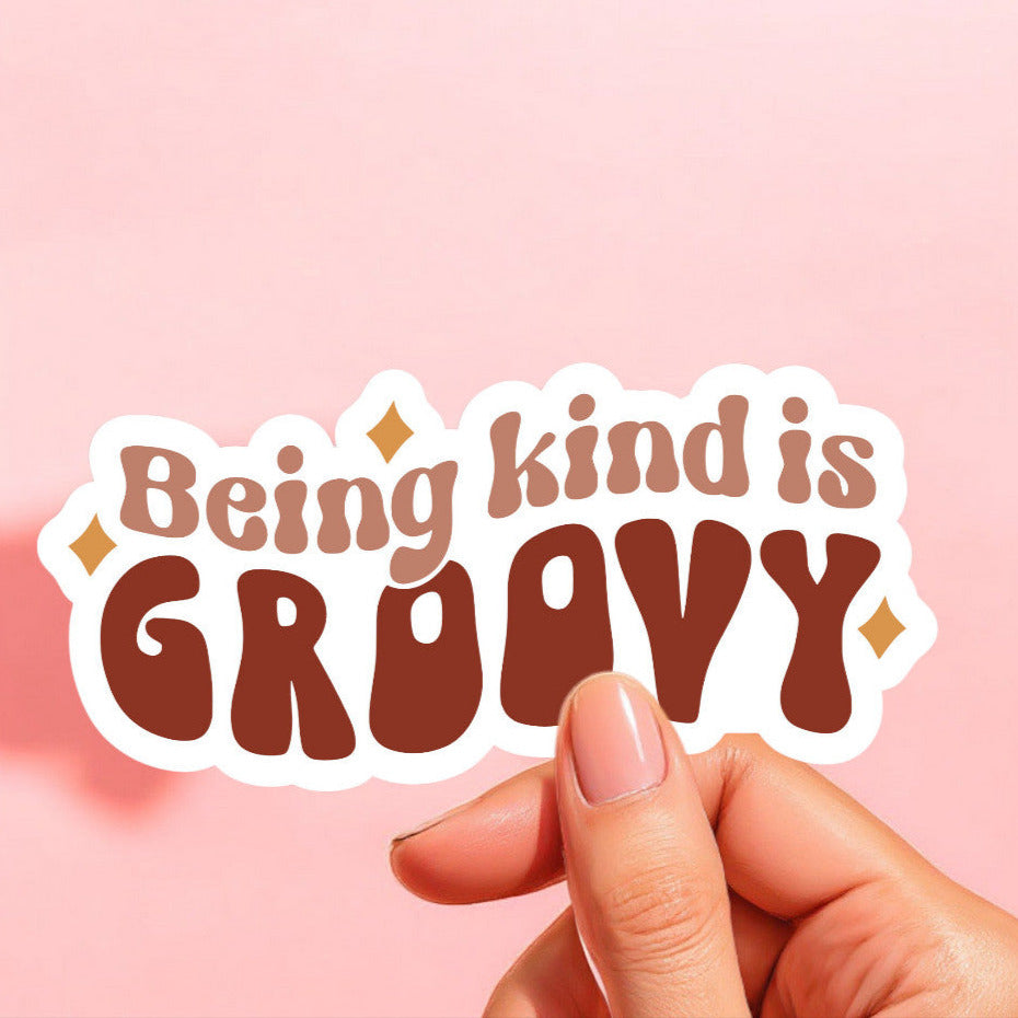 a sticker that reads being kind is groovy in taupe brown and brown with mustard yellow stars