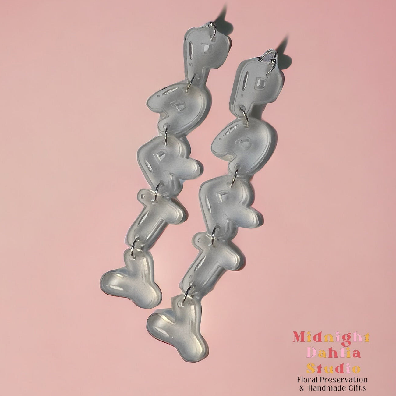 clear frosted acrylic earrings with each letter of party being a separate piece held together with silver plated hardware. a perfect accessory jewelry for new years and any party.
