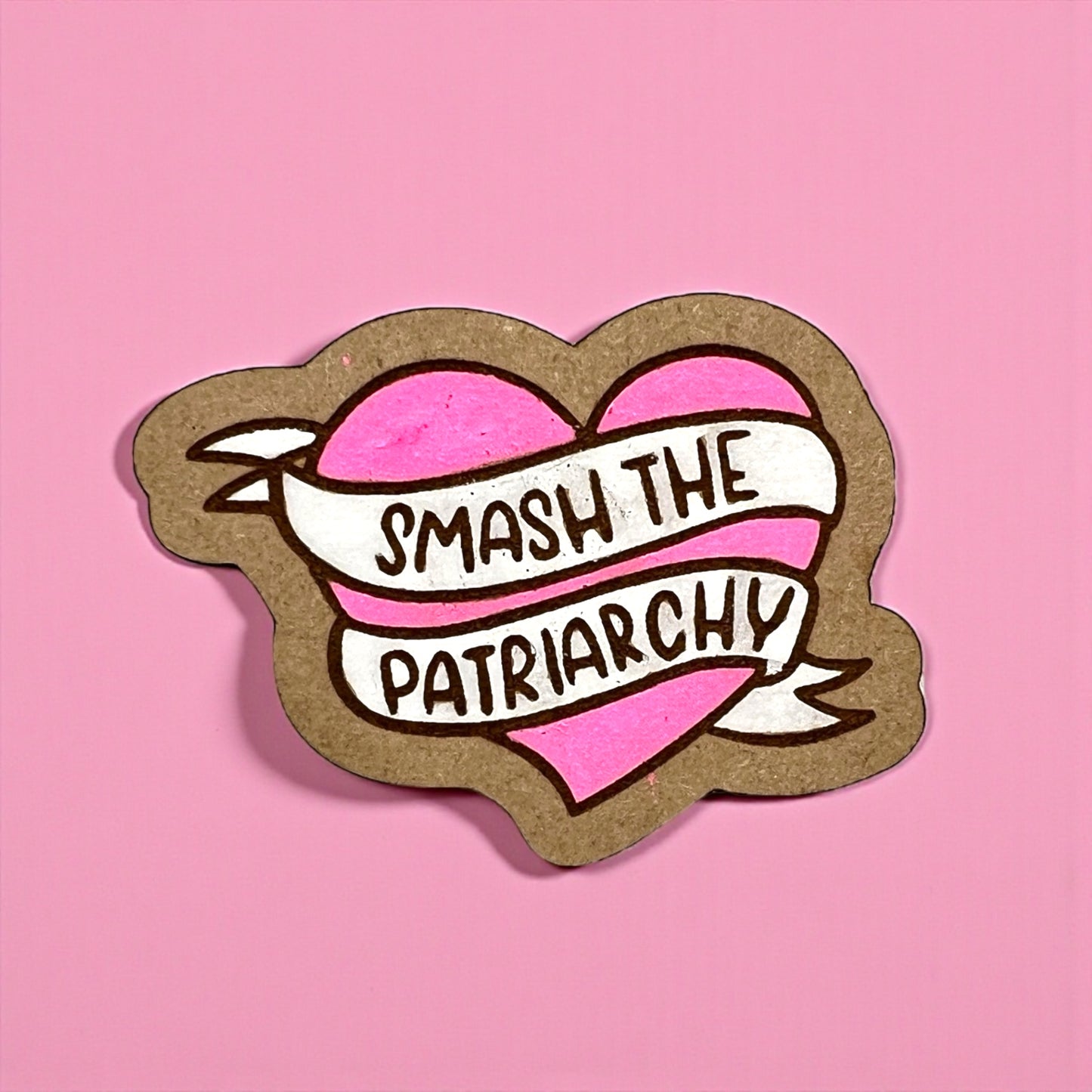 Heart-shaped sticker with 'Smash the Patriarchy' text on a pink background