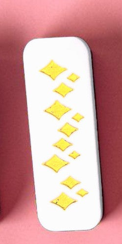 White rectangular object with yellow patterns on a pink background