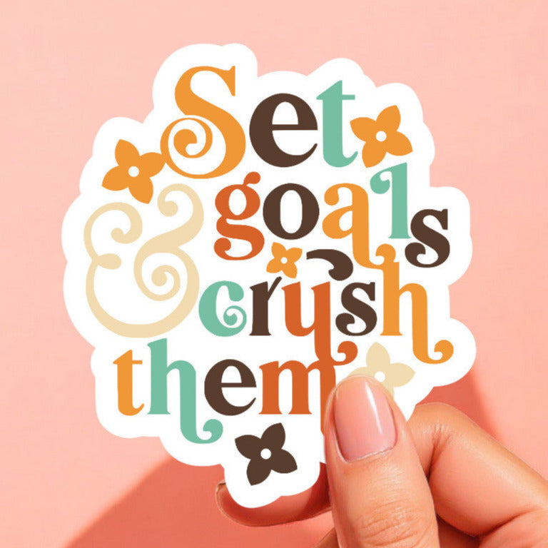 a sticker that reads set goals and crush them in colorful type