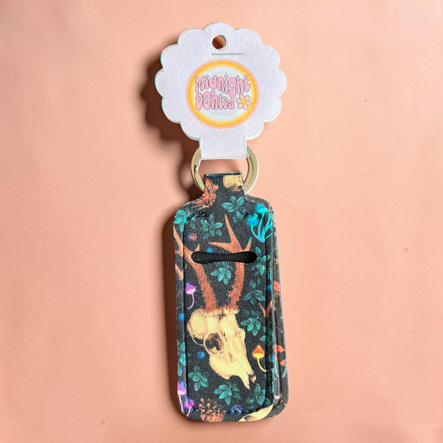 Keychain with floral and animal design on a pink background