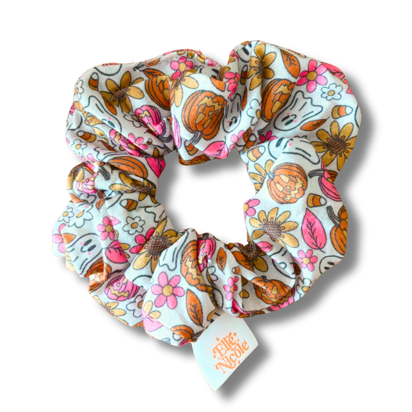 Floral patterned scrunchie with a visible brand tag on a white background