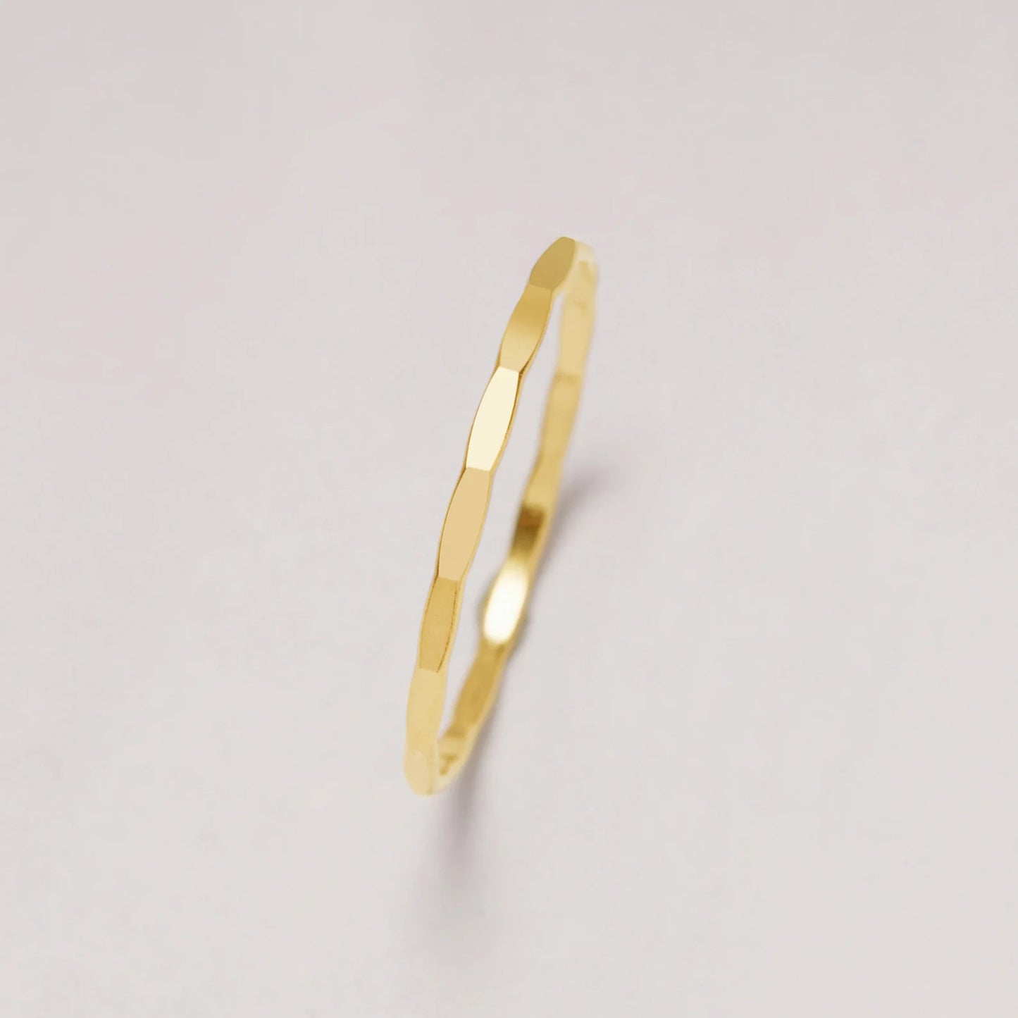 Gold ring on a light gray background