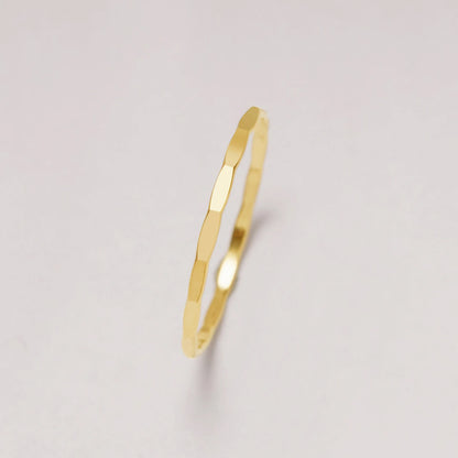 Gold ring on a light gray background