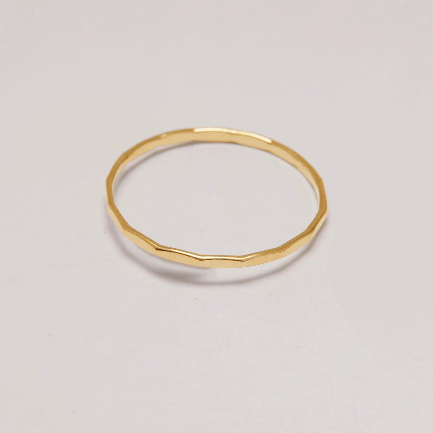 Gold ring on a light gray background