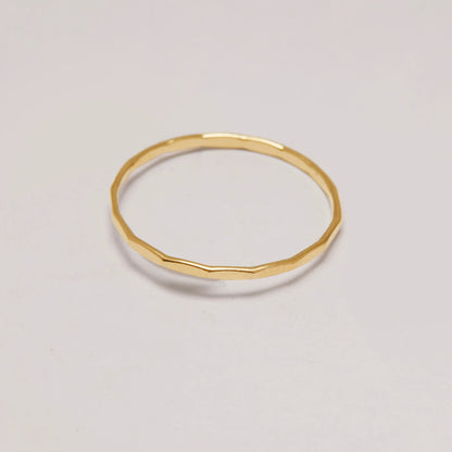 Gold ring on a light gray background