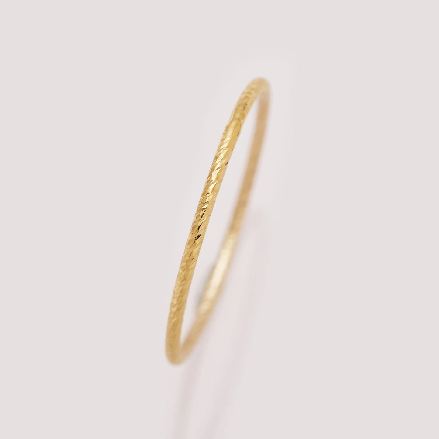 Gold ring on a light gray background