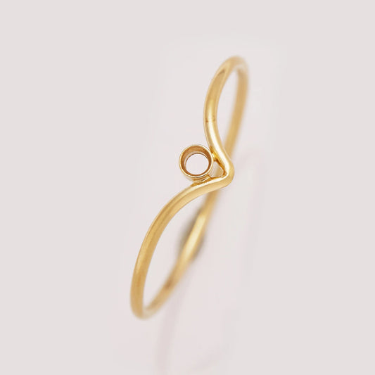 Gold ring with a unique design on a light gray background