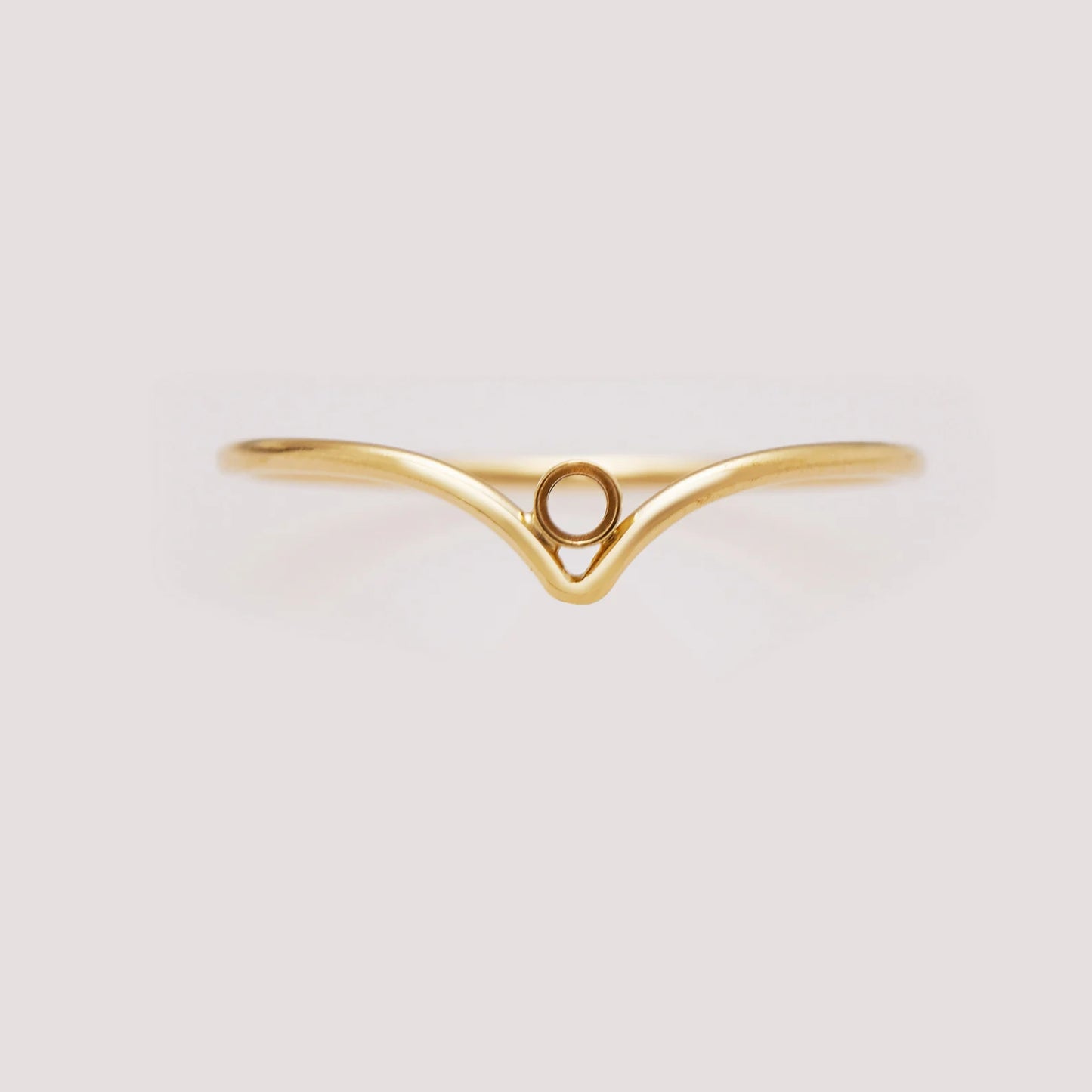 Gold ring with a unique design on a light gray background