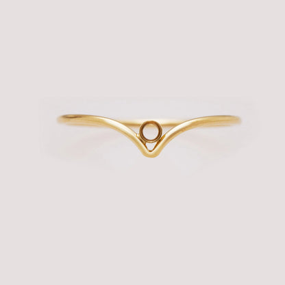 Gold ring with a unique design on a light gray background
