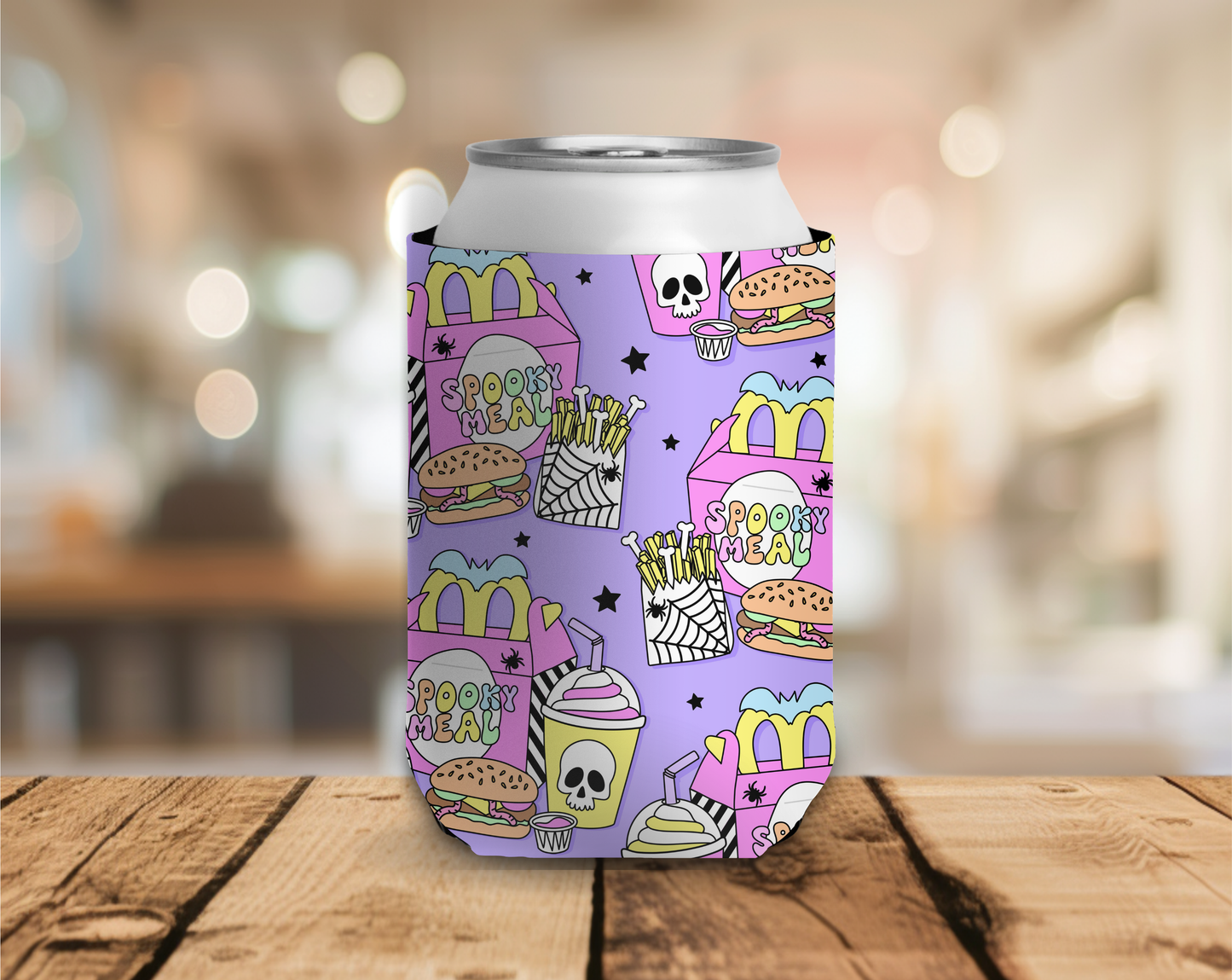 Colorful can cooler with fast food-themed design on a wooden surface.