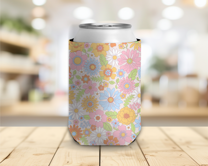 Floral-patterned can cooler on a wooden surface with a blurred background