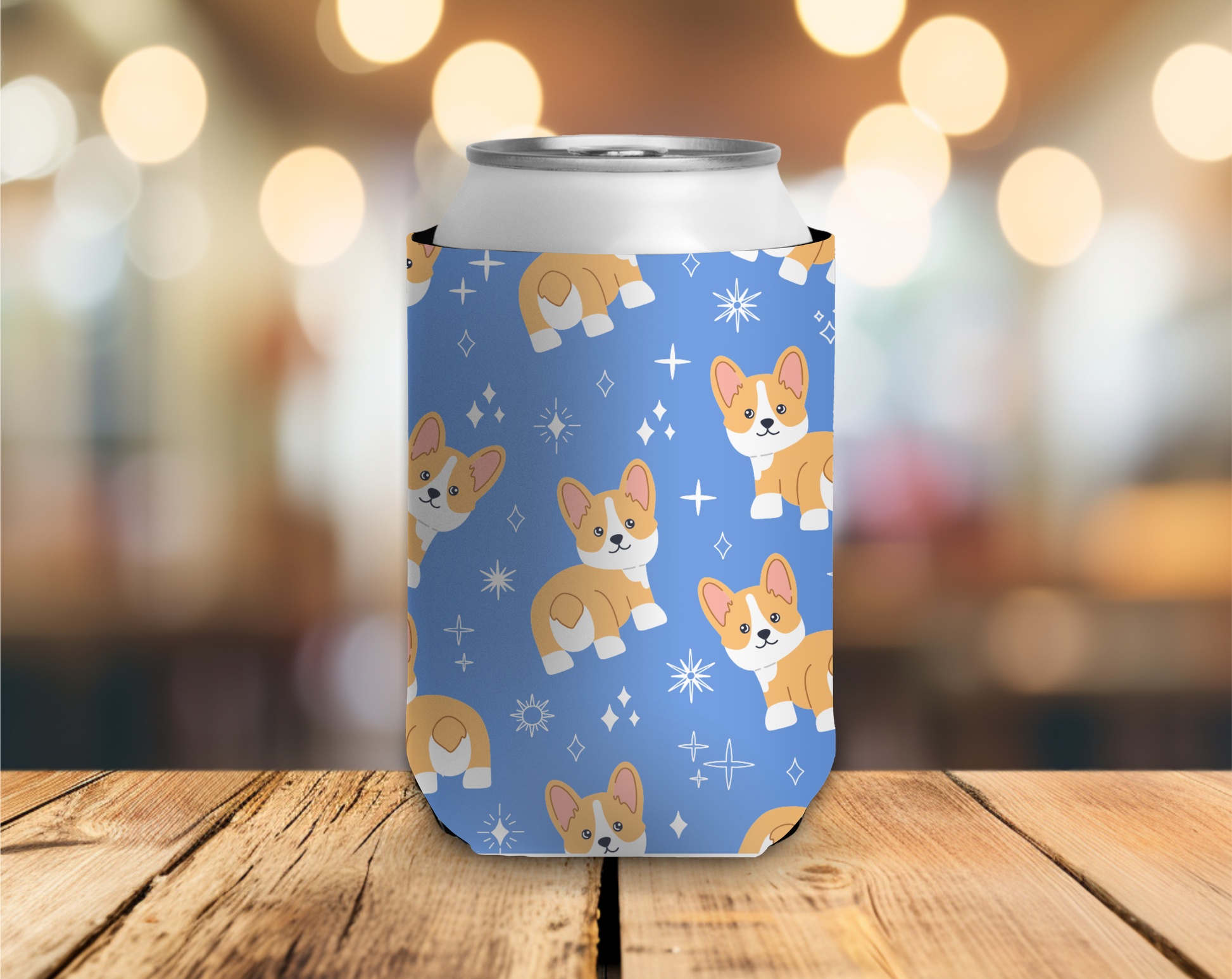 Can cooler with corgi pattern on a wooden table with blurred lights in the background