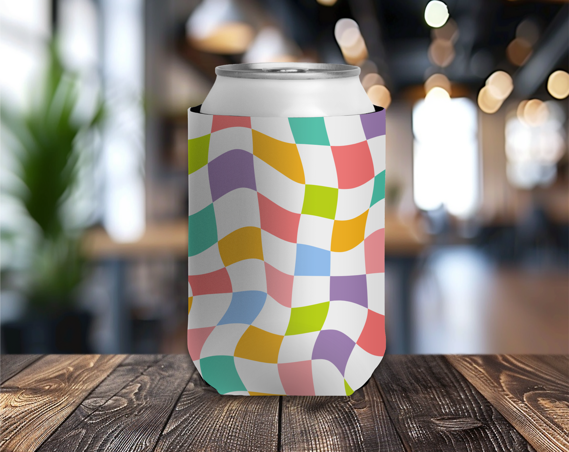 Colorful can cooler with a geometric pattern on a wooden table.
