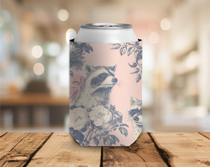 Can with floral and raccoon design on a wooden surface with a blurred background
