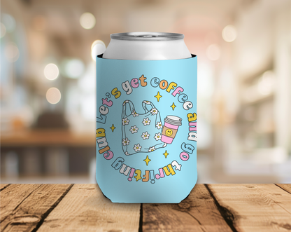 Light blue can cooler with colorful text and graphics on a wooden surface with a blurred background