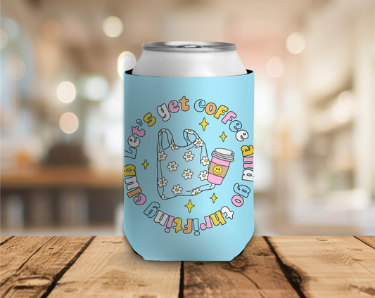 Light blue can cooler with colorful text and graphics on a wooden surface with a blurred background