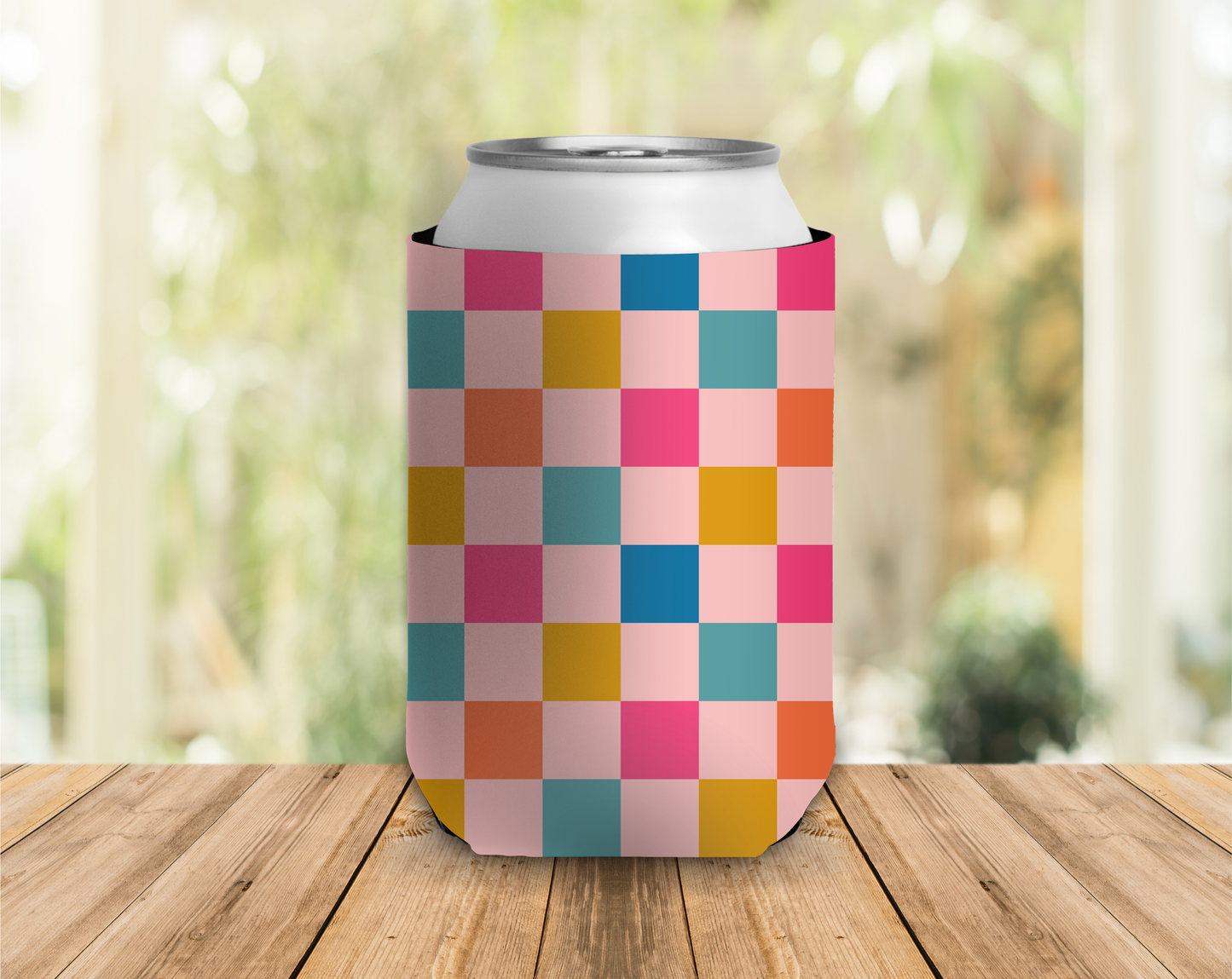 Colorful checkered can cooler on a wooden surface with a blurred outdoor background