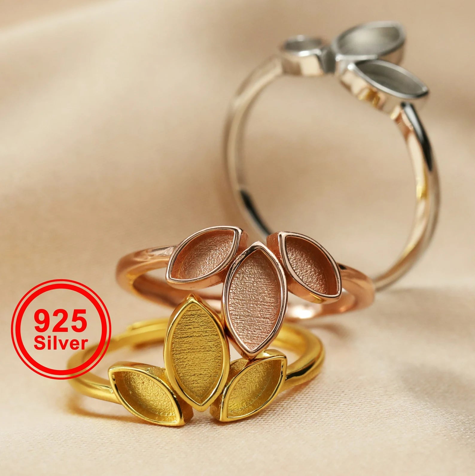 Three silver rings with leaf designs on a beige background, featuring '925 Silver' label.