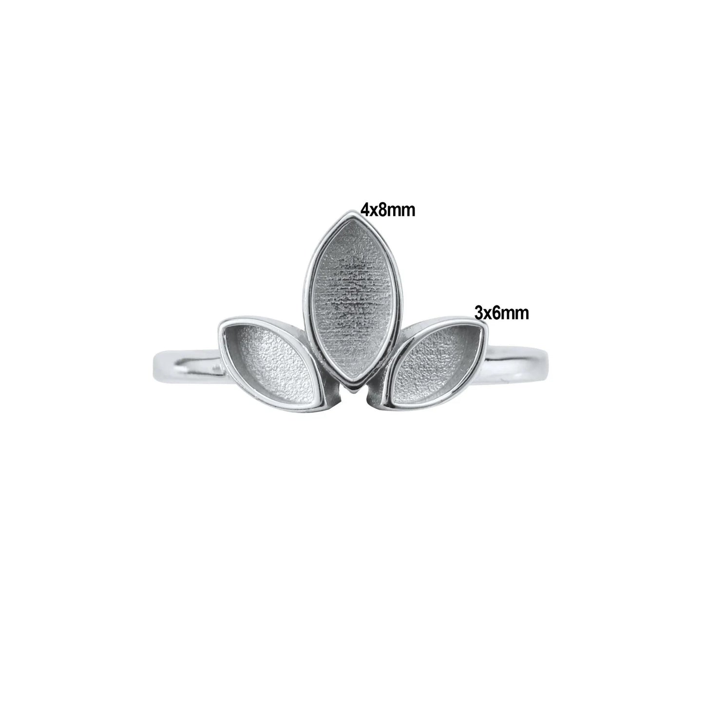 Silver ring with leaf-shaped stones of different sizes on a white background
