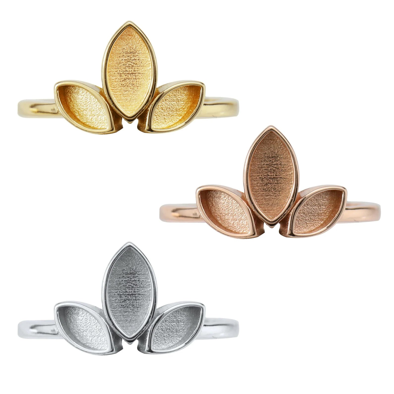 Three leaf-shaped rings in gold, rose gold, and silver on a white background