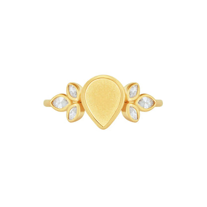 Gold ring with teardrop design and clear stones on a white background