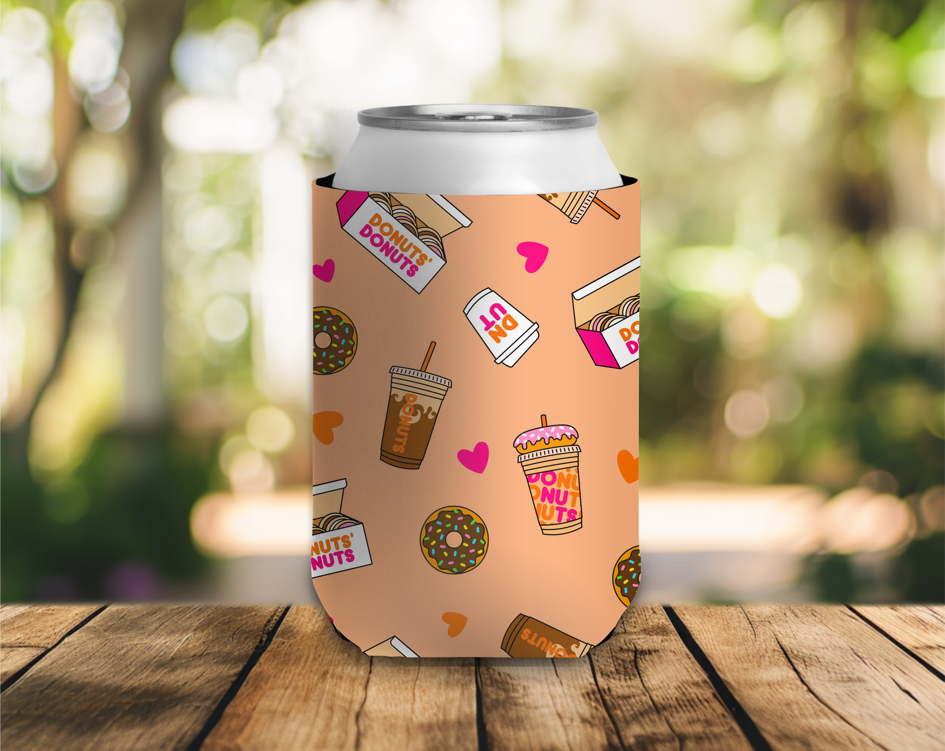 Can cooler with donut-themed design on a wooden table outdoors