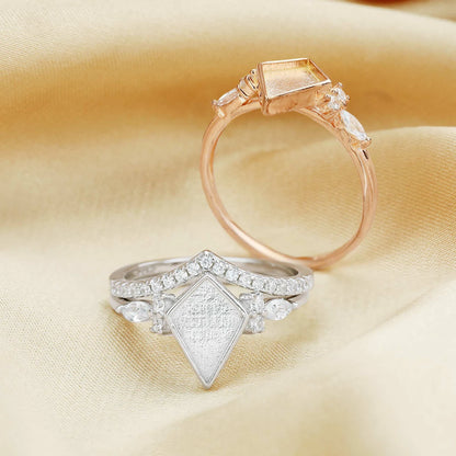 Two diamond rings on a beige fabric background