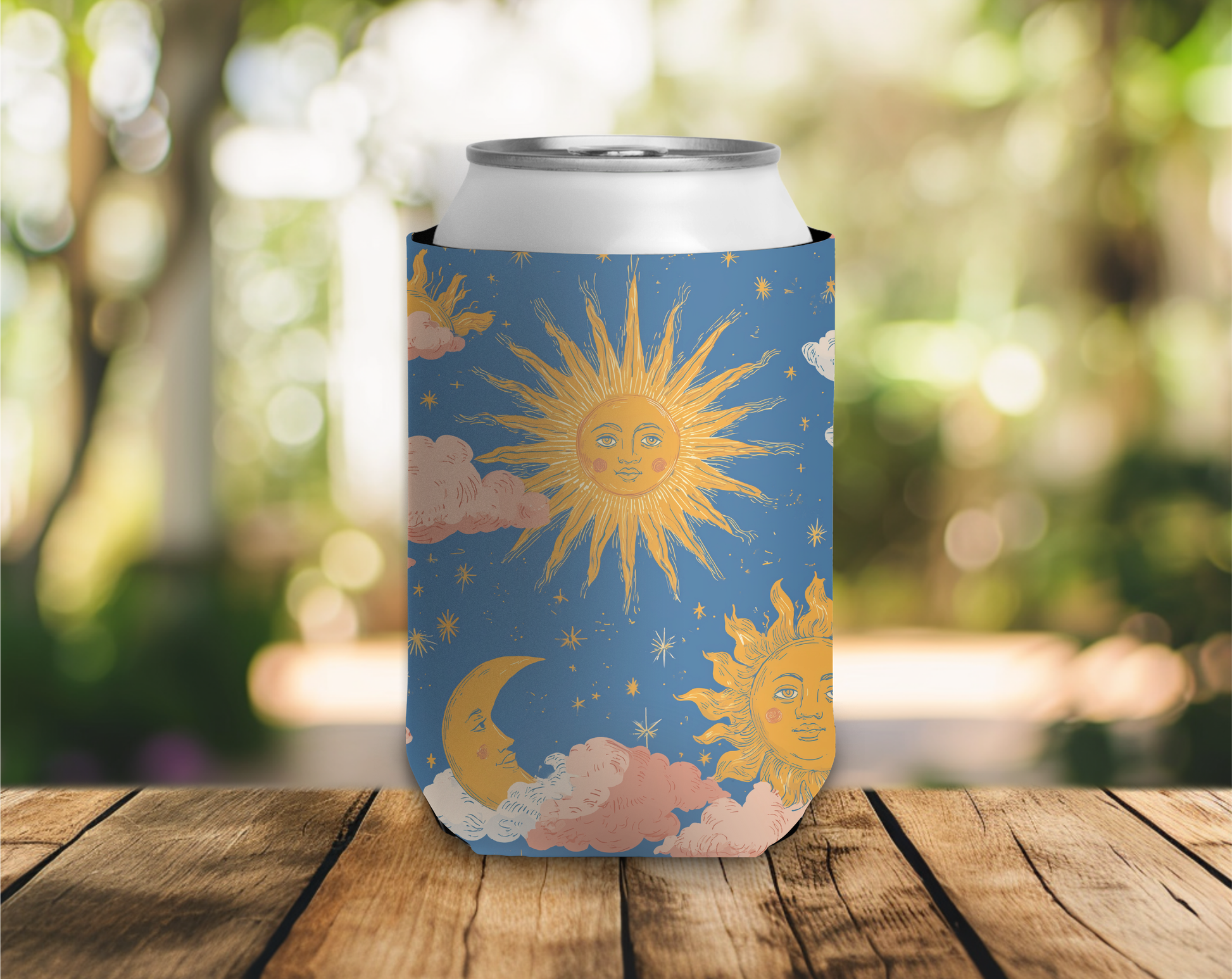 Can cooler with sun and moon design on a wooden surface with a blurred natural background