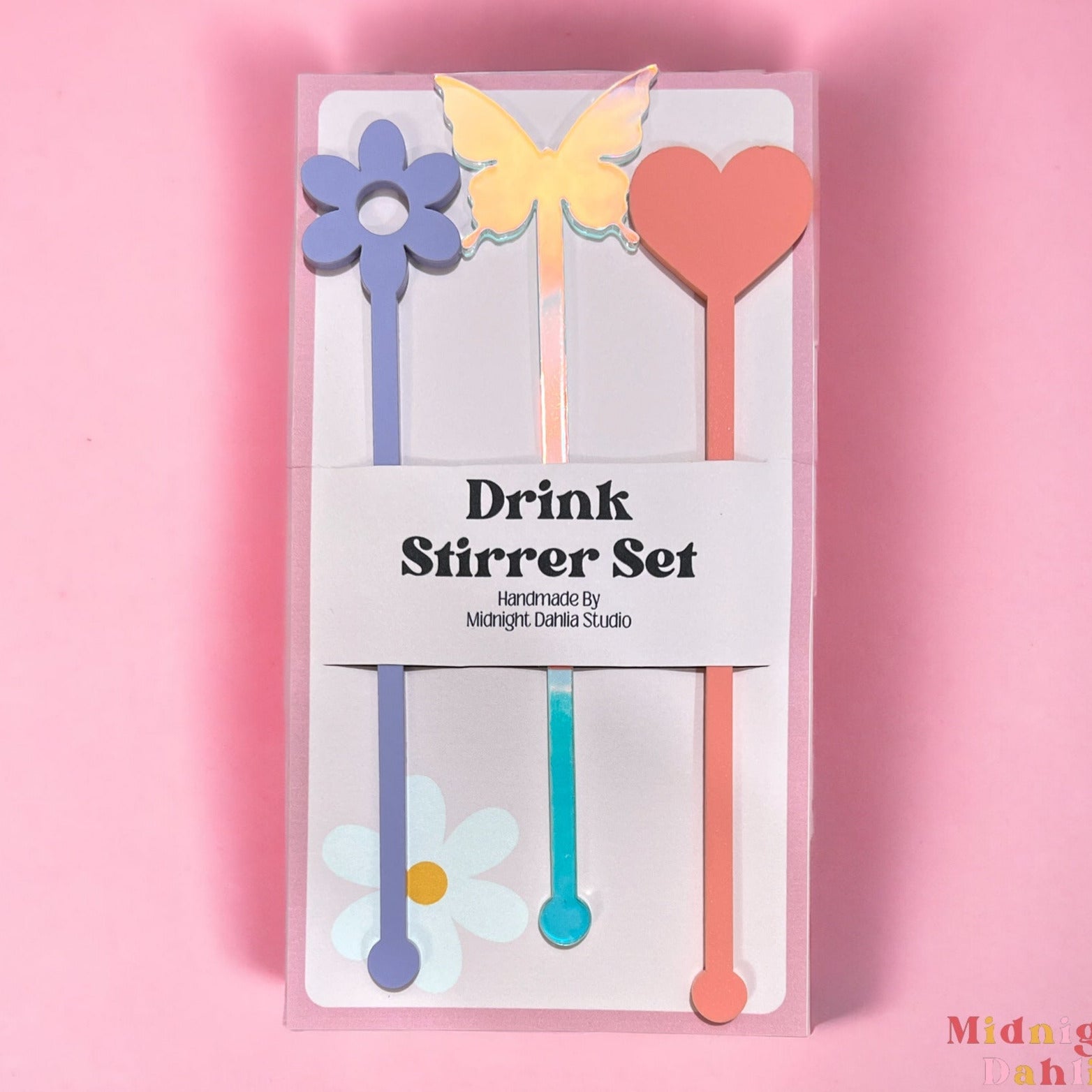 three drink stirrers with the top shaped in a daisy, butterfly, and heart in lavender purple, iridescent, and pink coral.