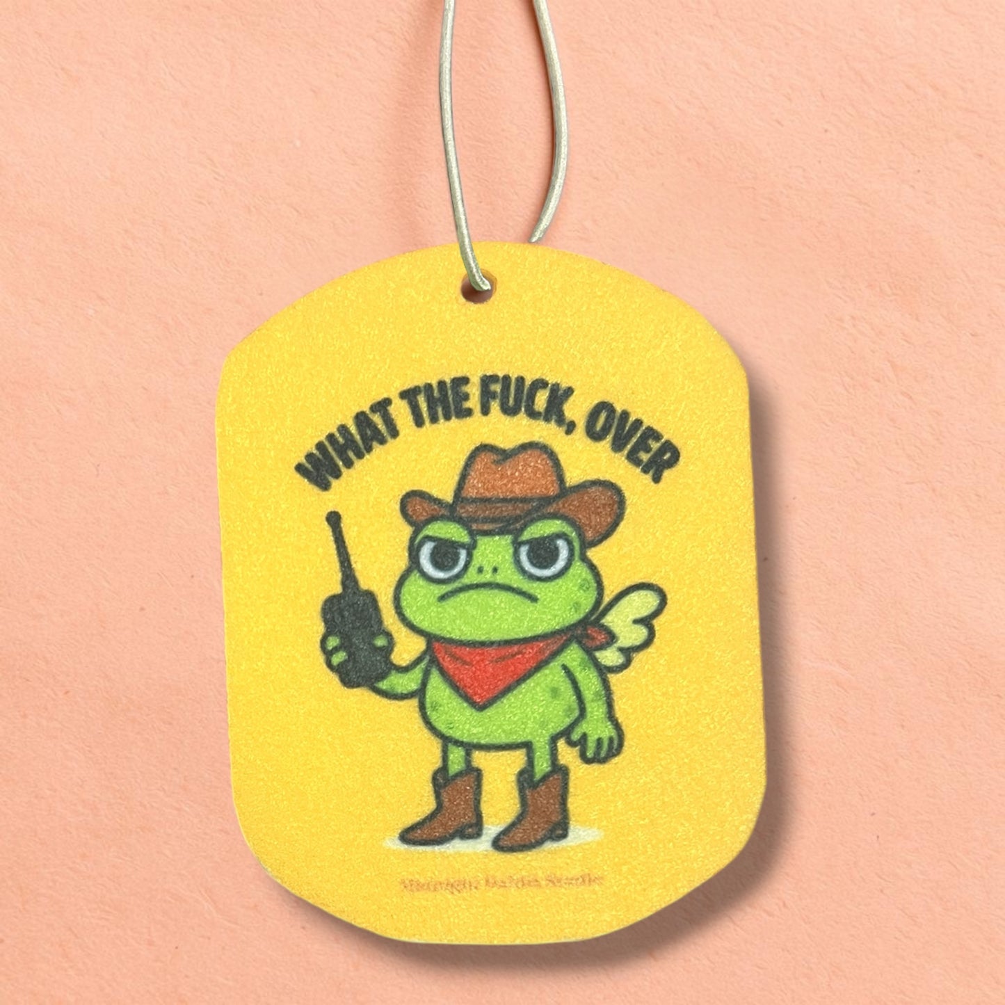 Yellow tag with a cartoon frog character and text on a pink background