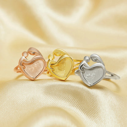 Three heart-shaped rings in rose gold, yellow gold, and silver on a satin background