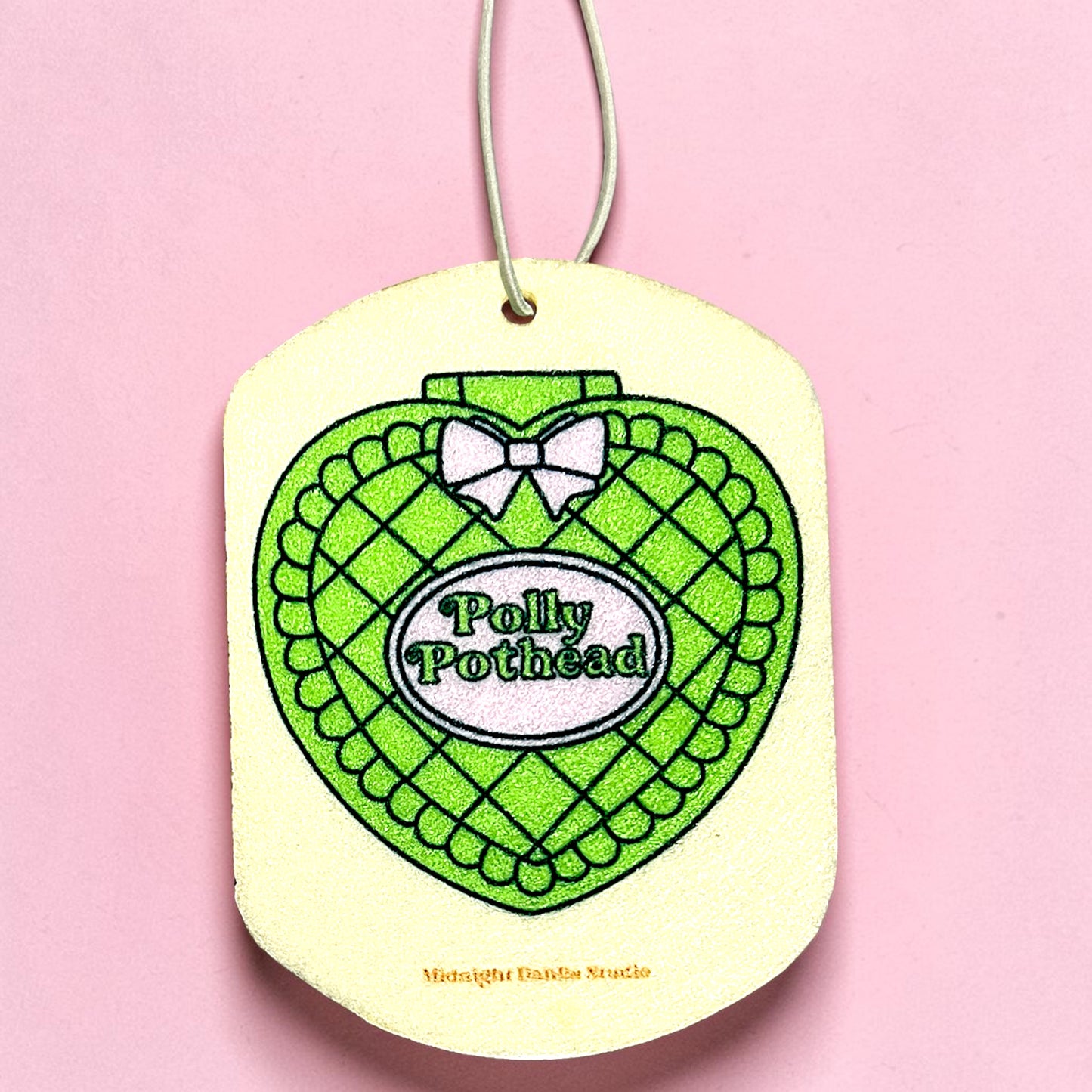 Heart-shaped green and white product with 'Polly Pothead' text on a pink background