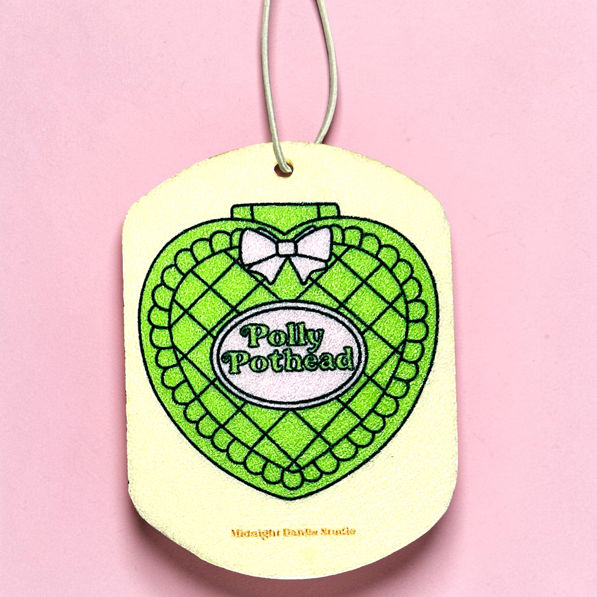 Heart-shaped green and white product with 'Polly Pothead' text on a pink background
