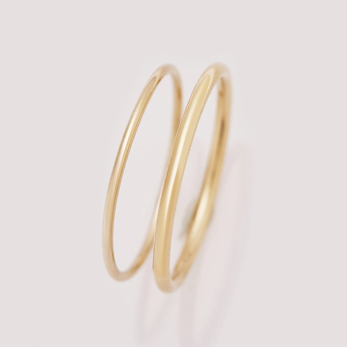 Gold hoop earrings on a light gray background