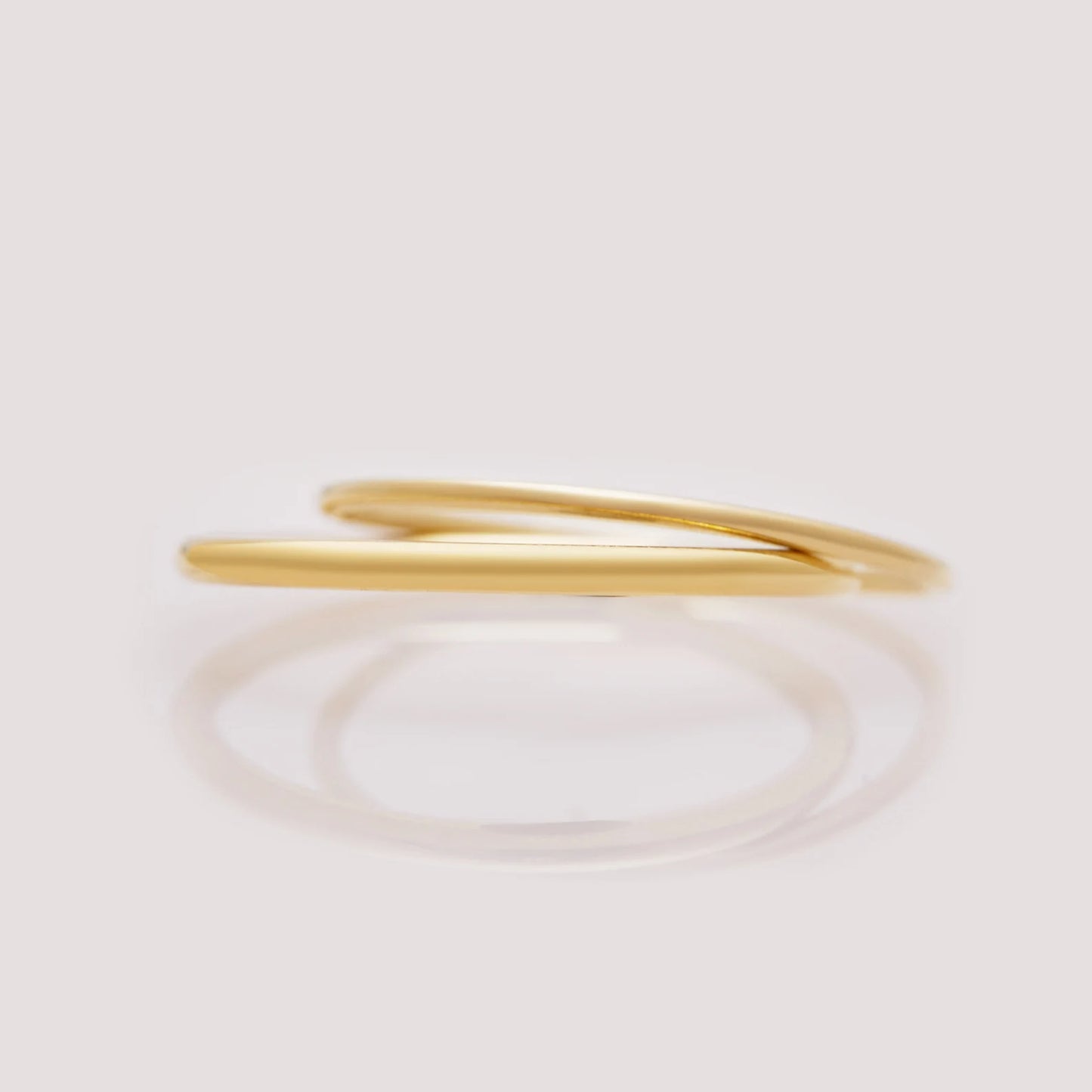 Gold ring on a light beige background