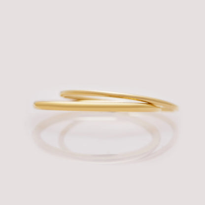 Gold ring on a light beige background