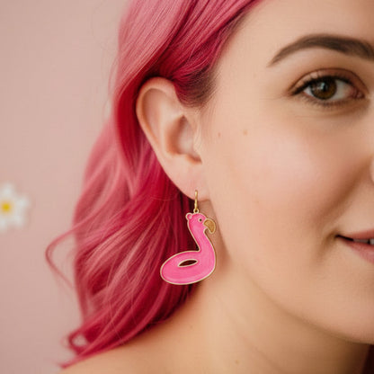 Woman with pink hair wearing a pink snake-shaped earring against a floral background