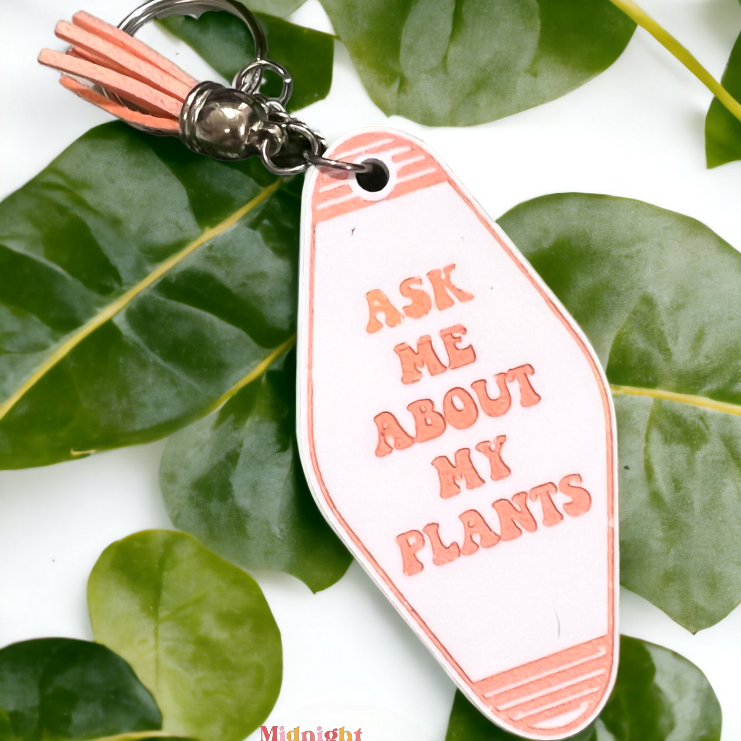 a retro motel keychain made of acrylic that reads "ask me about my plants"