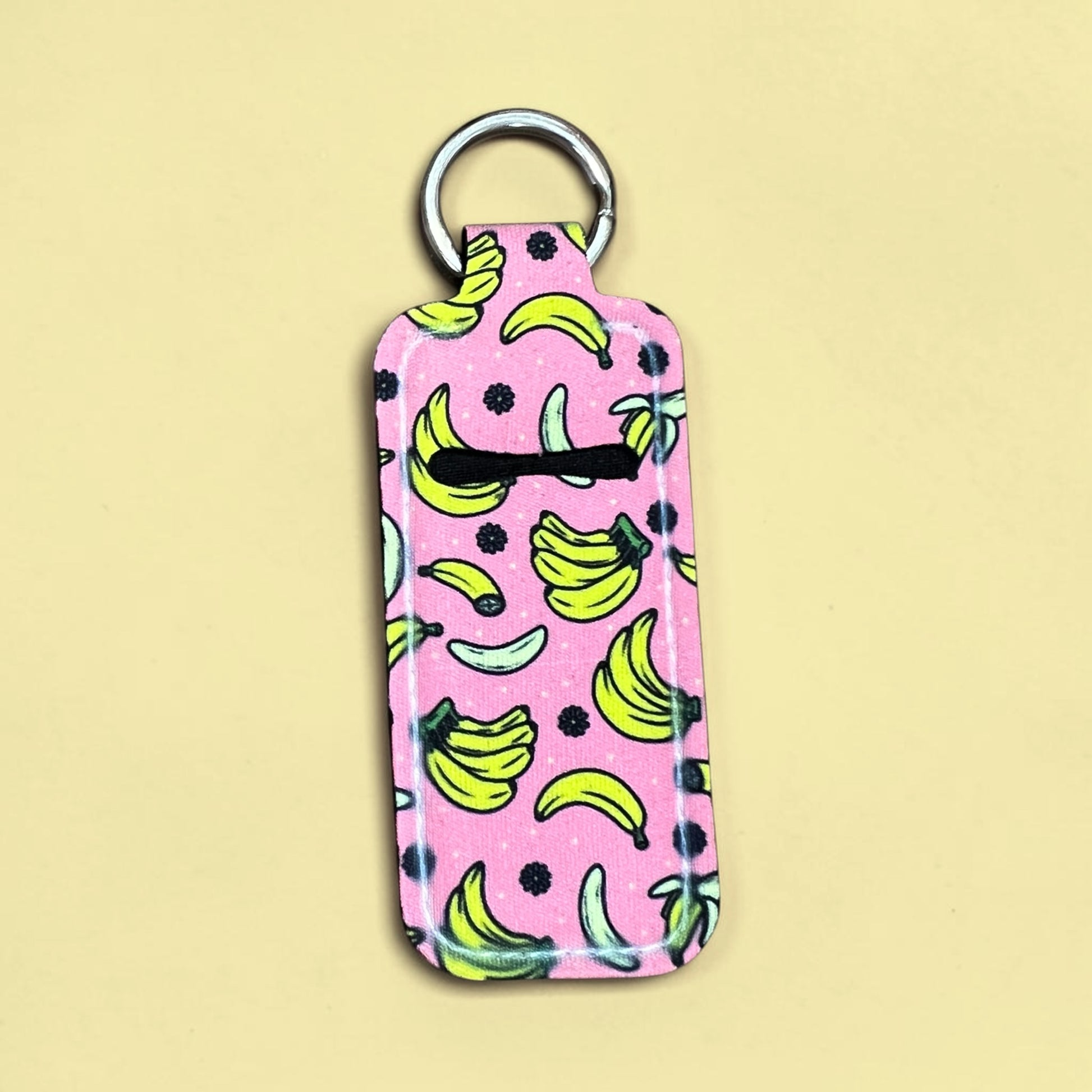 Keychain with banana pattern on a pink background