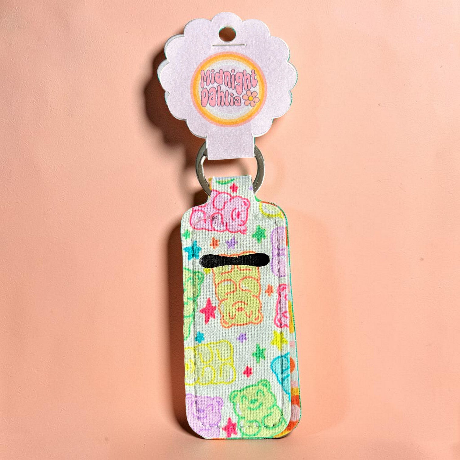 Colorful keychain with cartoon bear design on a pink background