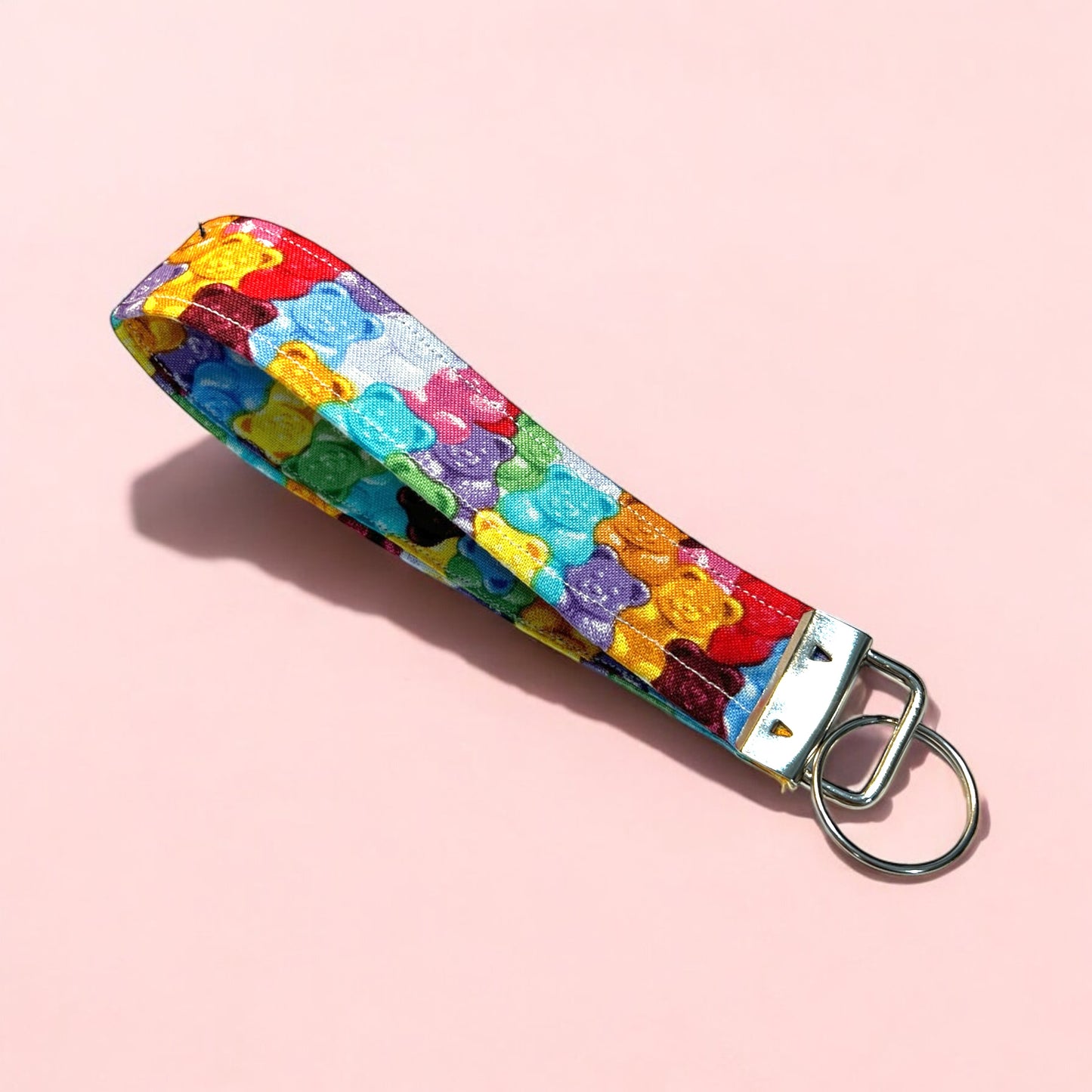 a handmade fabric wristlet keychain key chain against a pastel background