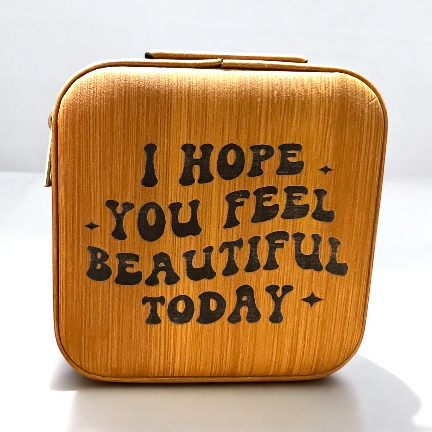 a brown bamboo color jewelry box engraved in black with 'i hope you feel beautiful today'